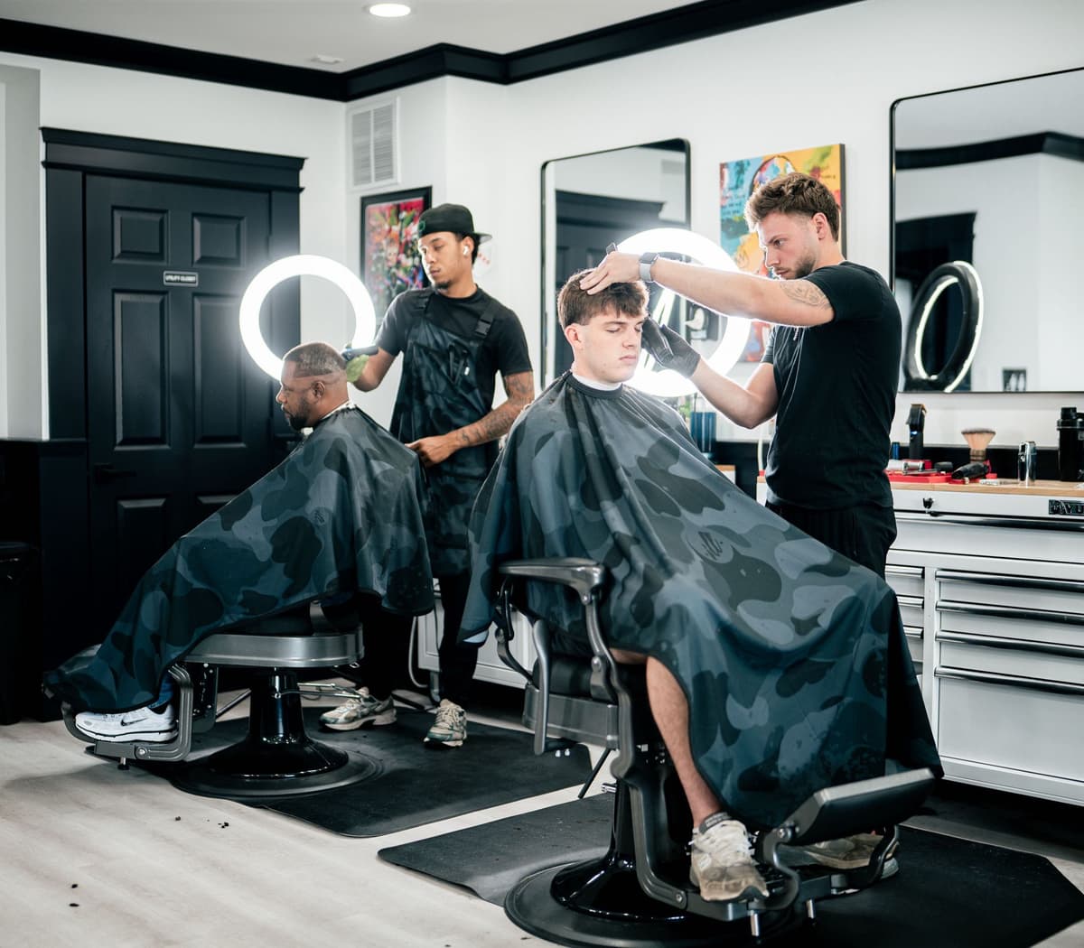 Two barbers working side by side