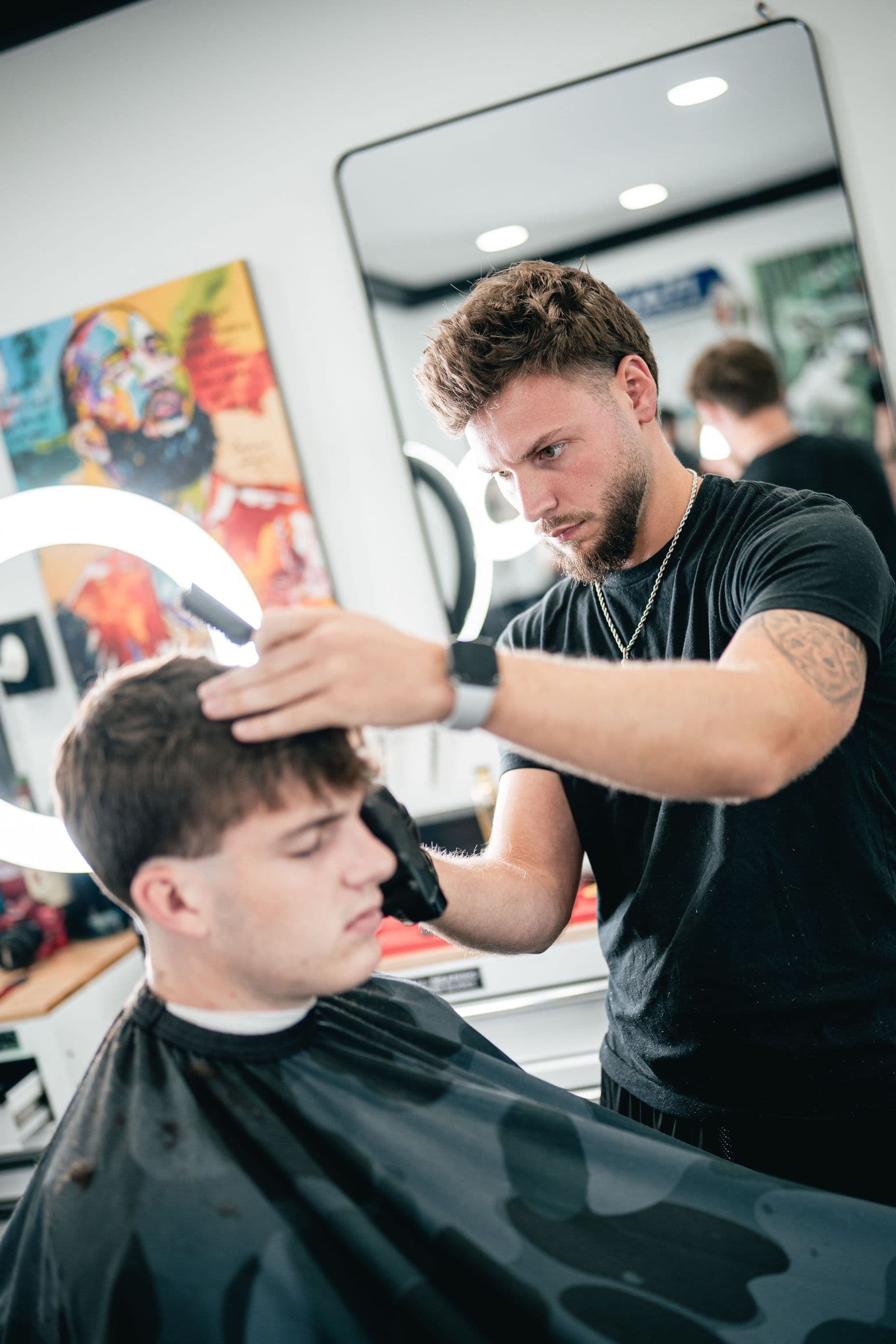 Barber crafting a textured crop at Colella Cutz