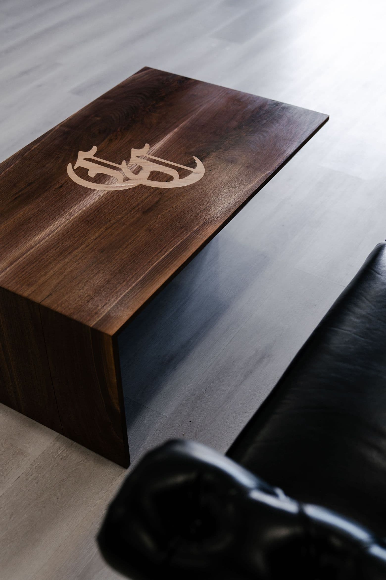 Custom Colella Cutz logo table in the lounge area