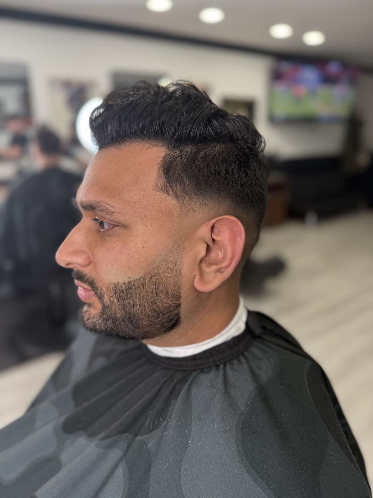 Finished mid fade with textured top and beard