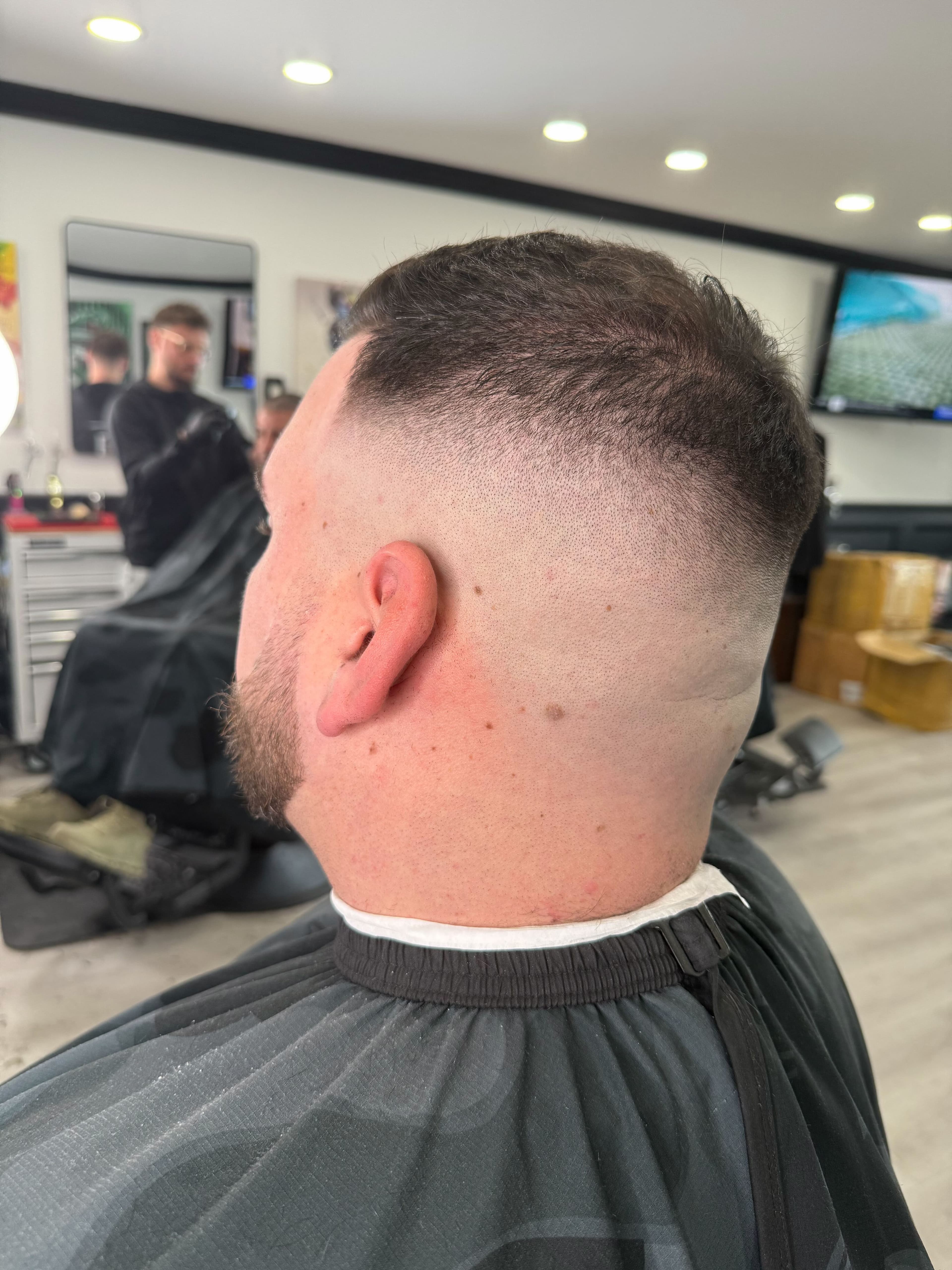 Clean taper fade, back view, at Colella Cutz Barber Studios
