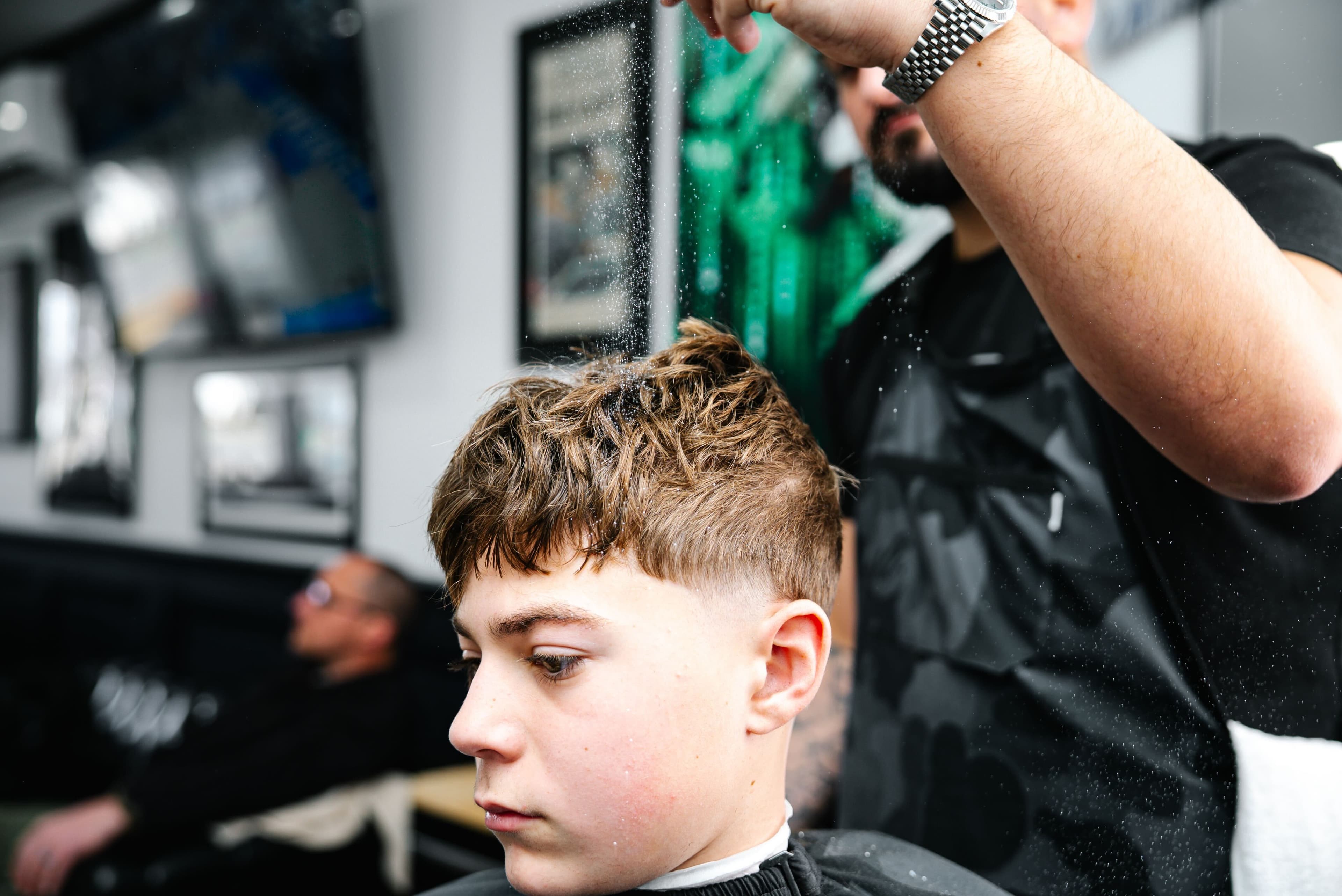 Finished textured fringe haircut with mid fade at Colella Cutz