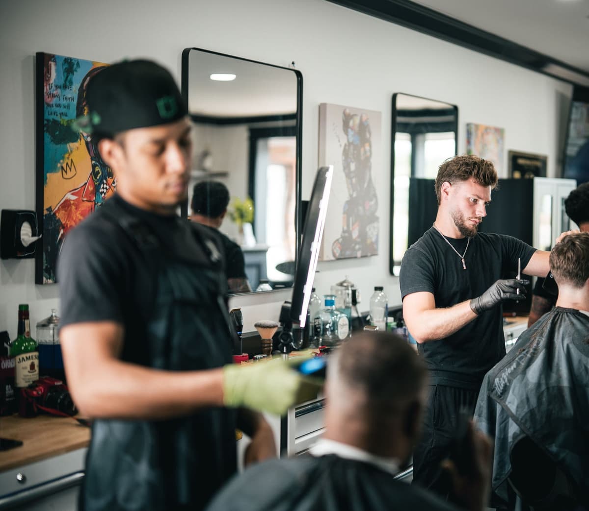 Two barbers working side by side