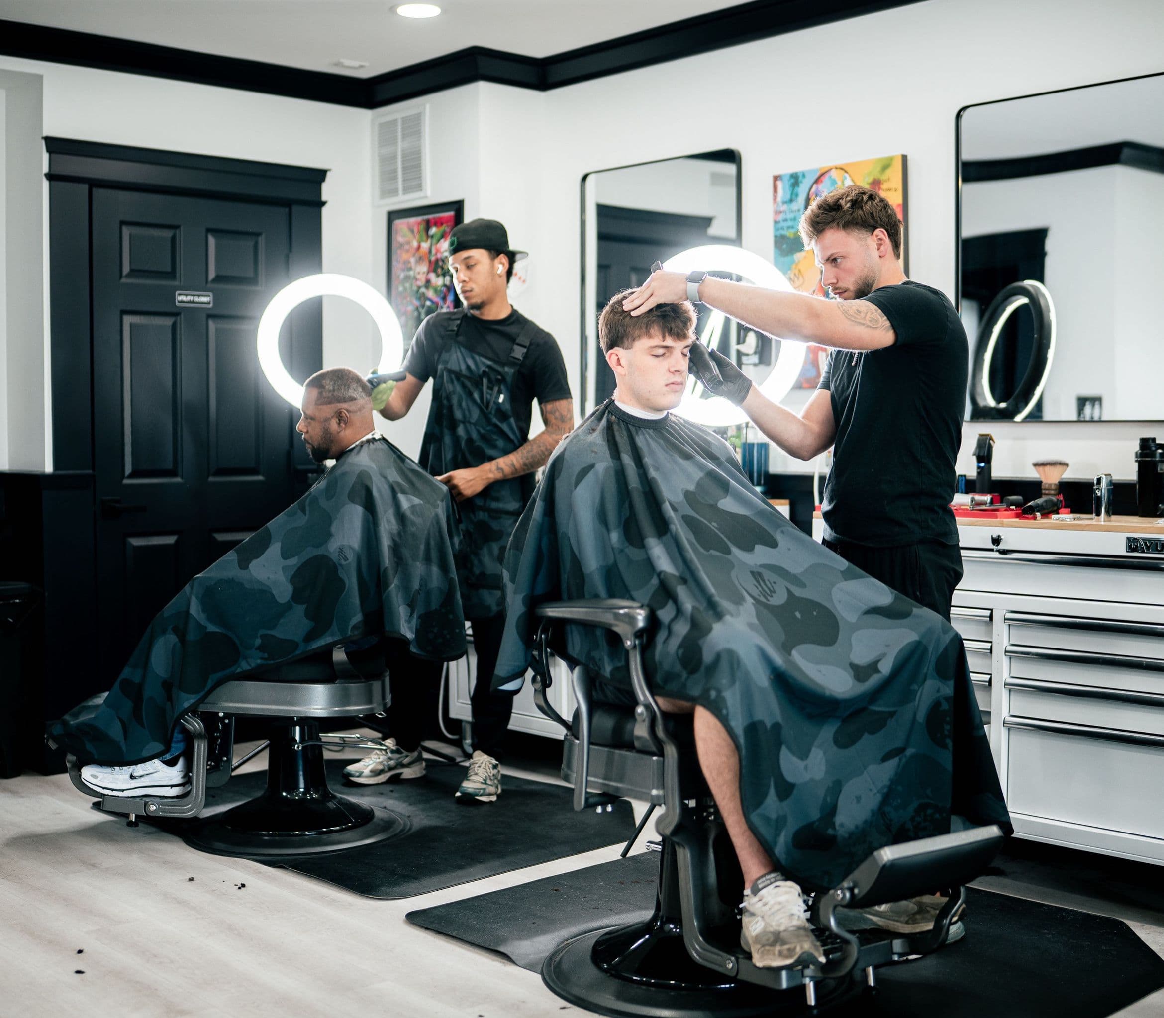 Two barbers working side by side